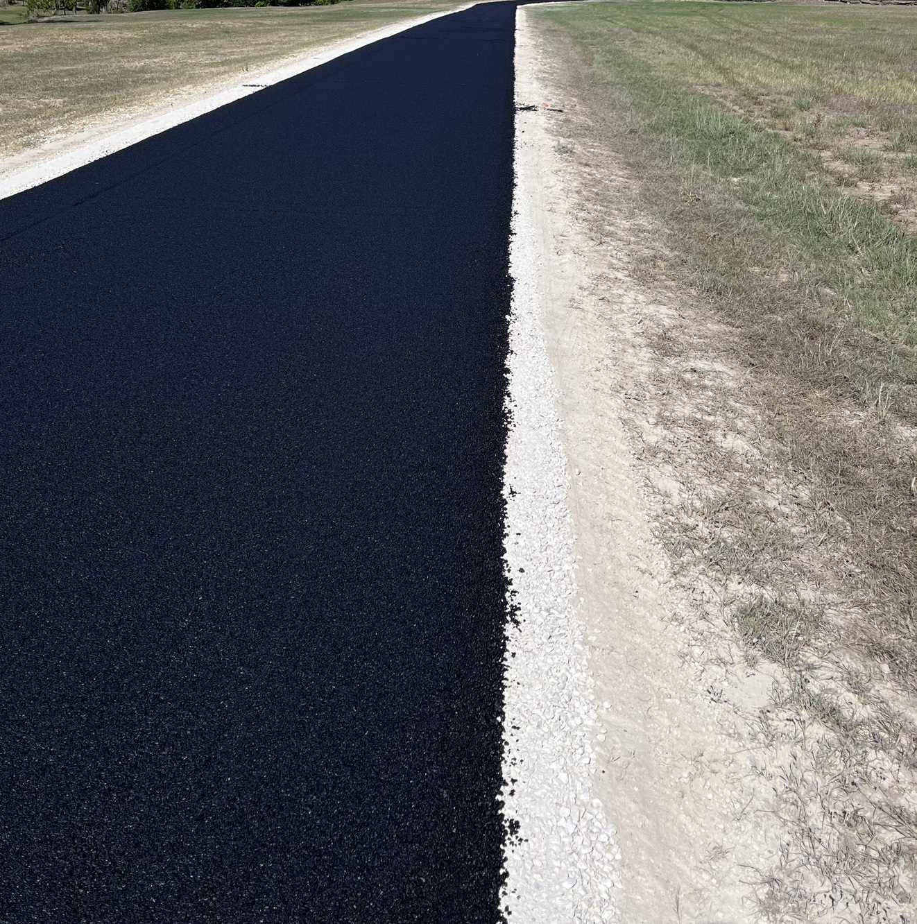 Clean asphalt edge with gravel border