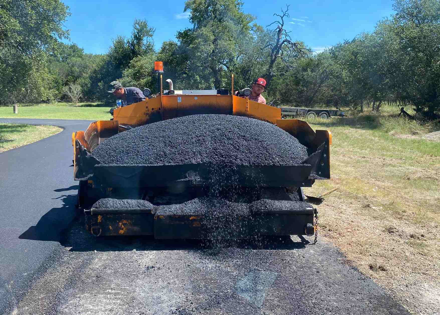 Paver hopper spreading asphalt
